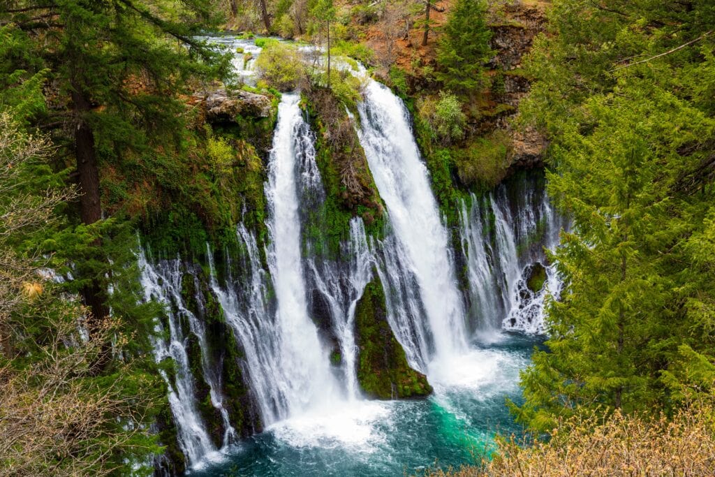 Wide landscape view of Burney Falls with the full pool and surrounding canyon walls at McArthur-Burney Falls Memorial State Park, California 