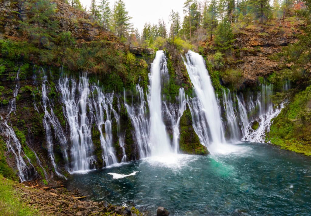 Central cascade of Burney Falls with water splitting across a moss-covered rock face at McArthur-Burney Falls Memorial State Park, California