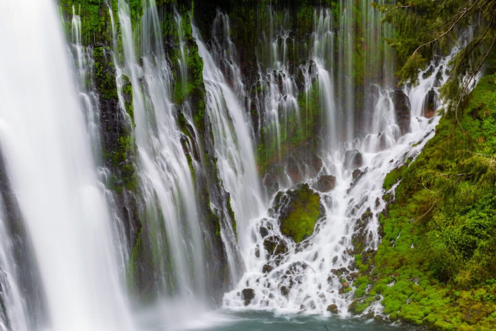 Burney Falls viewed straight-on showing the full spread of the cascade and mossy cliffs at McArthur-Burney Falls Memorial State Park, California