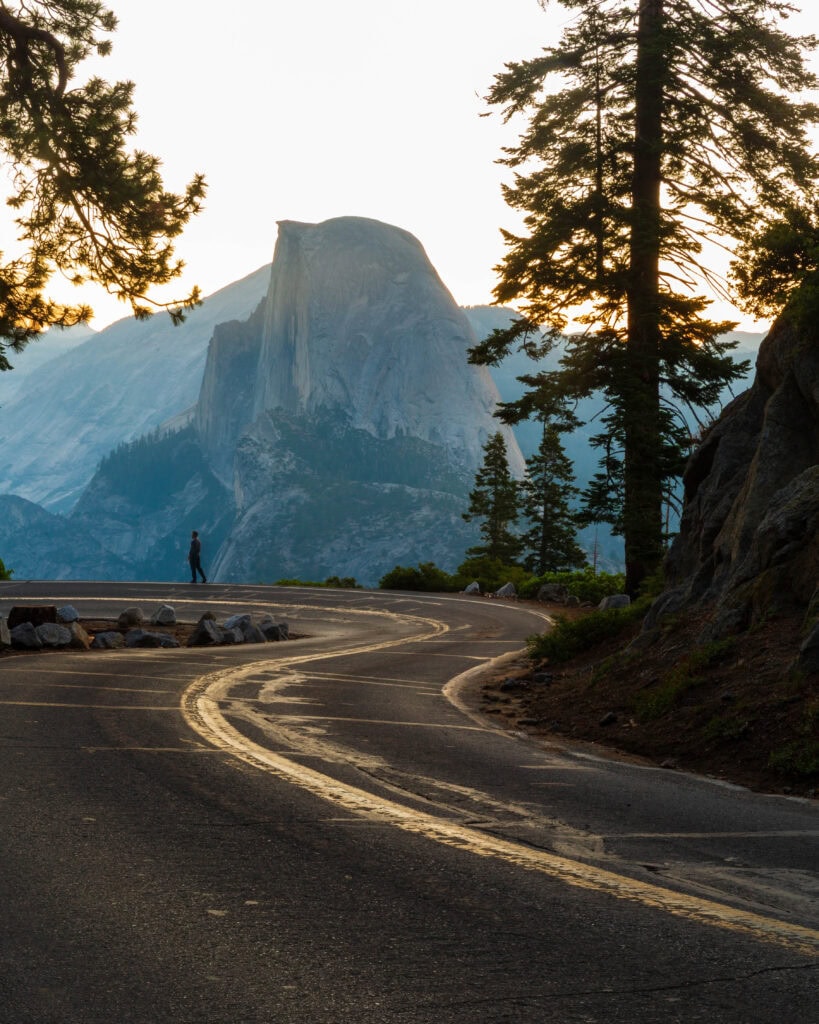 the author standing on the edge of the road at glacier point before sunrise