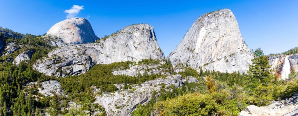 view of half dome and other granite mounds from the john muir trail