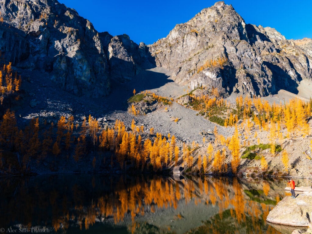 A hiker stands on a rock at Copper Glance Lake. 