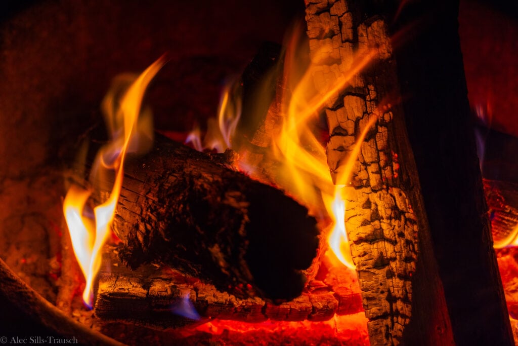 burning logs with flames from a campfire