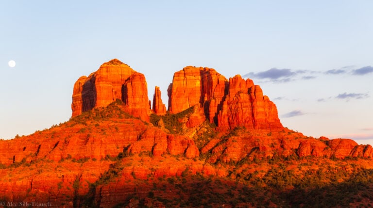 A view at sunset of Cathedral Rock lit up by the glowing of the sun.