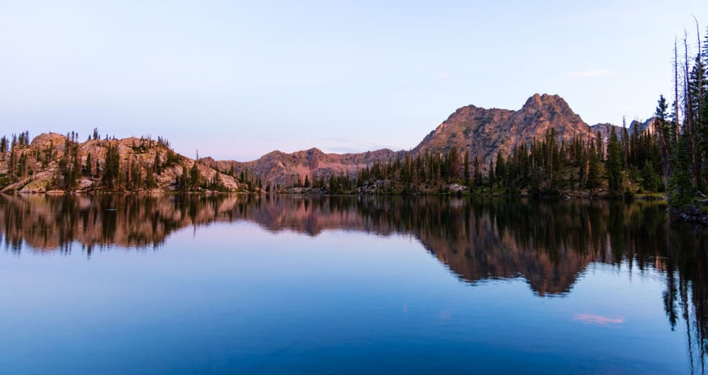 a wide view of gilpin lake at sunrise with a nice reflection