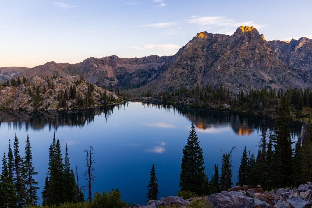 the tips of the peaks surrounding gilpin lake are hit with first light