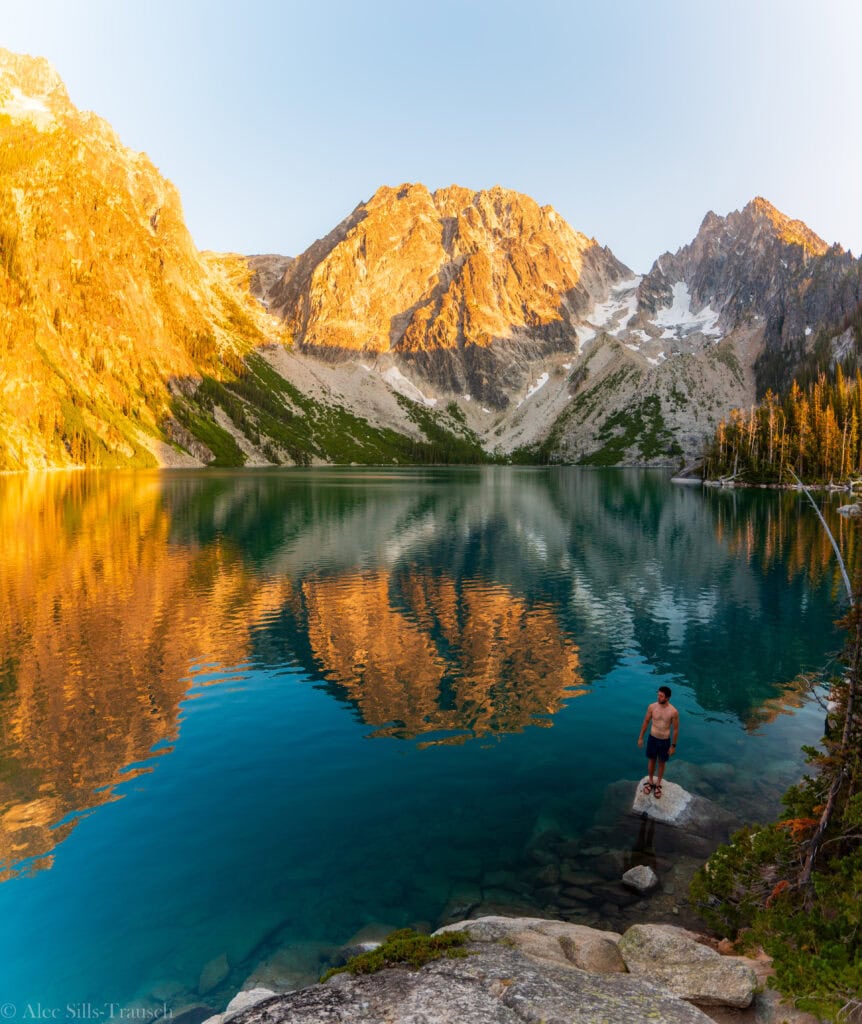 A solo hiker enjoys the views from the Colchuck Lake hike