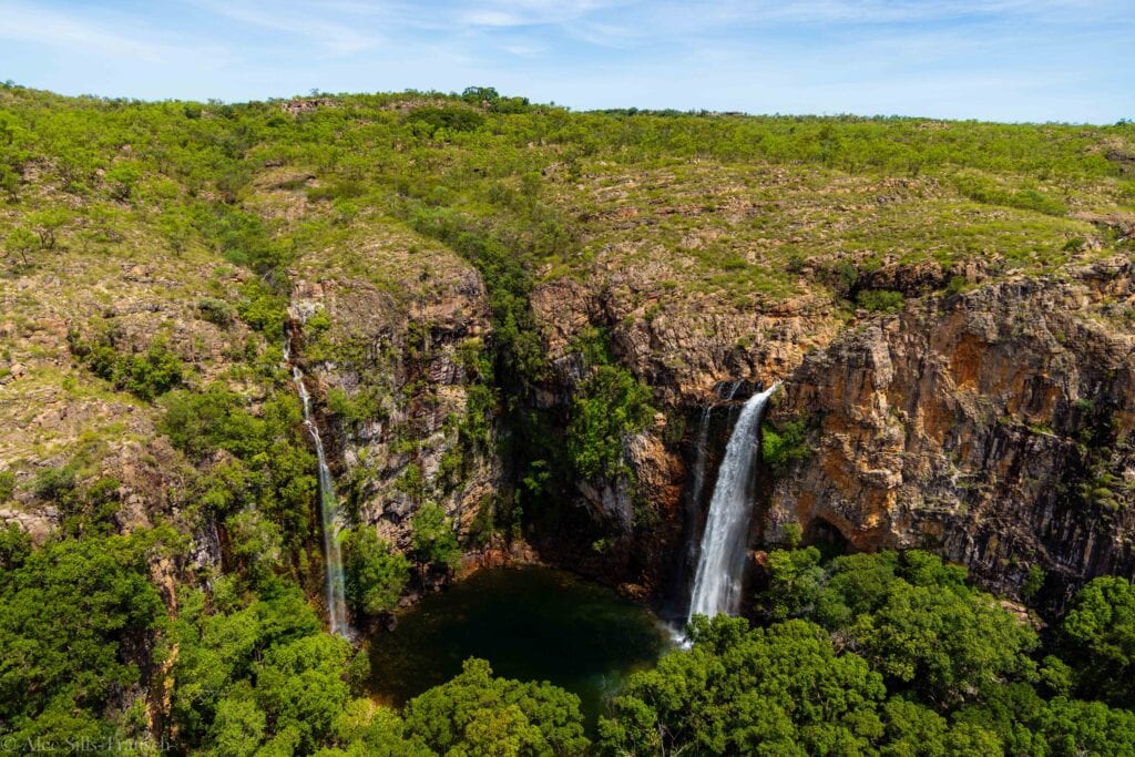 A double waterfall flowing into a pool below. 