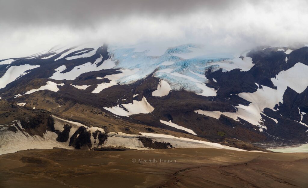 A glacier in the background with the valley of ten thousand smokes at the bottom