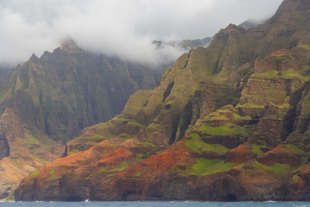 the green and rugged na pali coastline in hawaii as viewed from the ocean