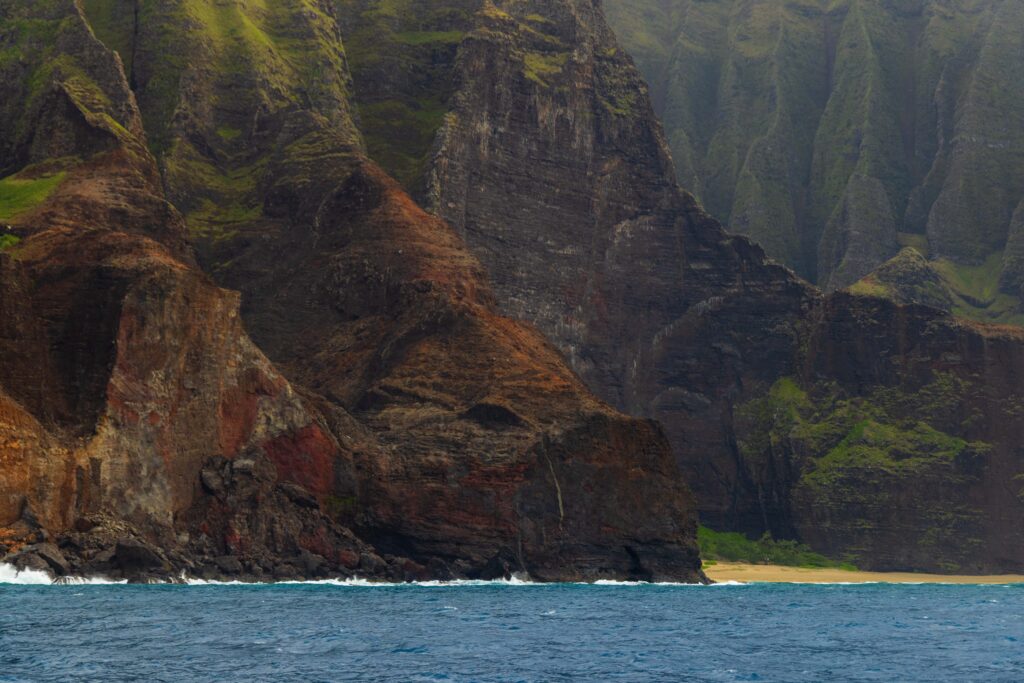 massive rock formations touching the pacific ocean in kauai