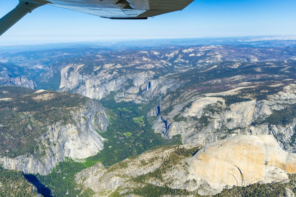 flightseeing tour over yosemite with the backside of halfdome below