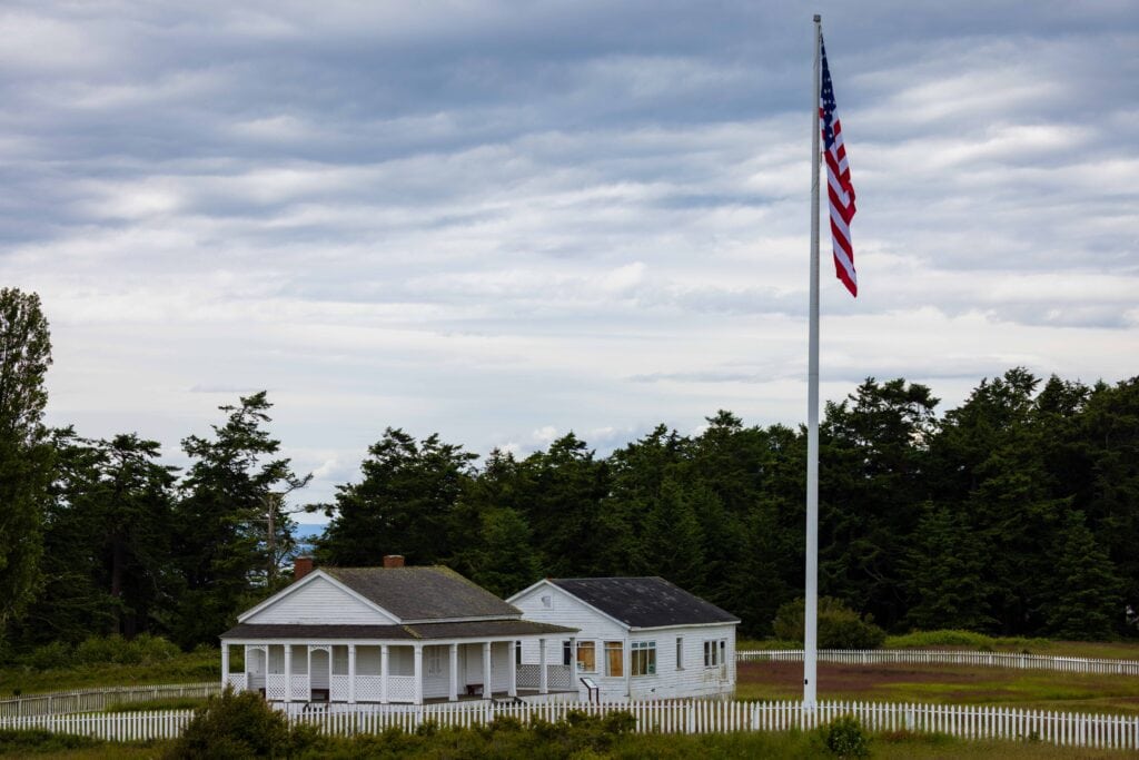 american camp with a giant flag rising