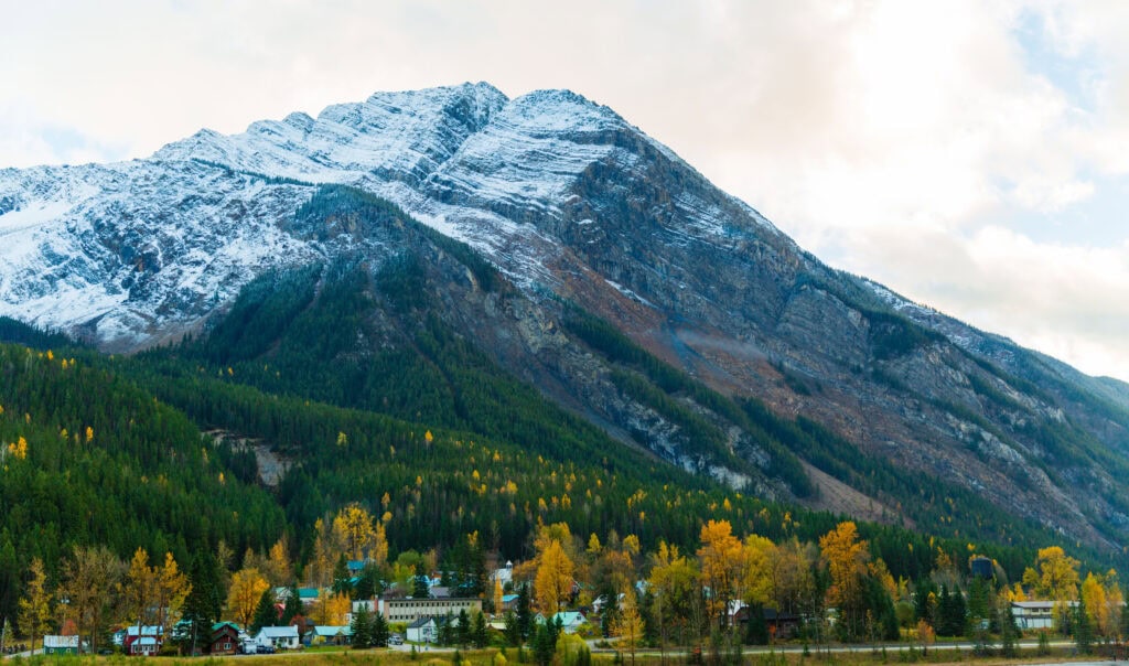the town of field british columbia with a snow on the peaks above it