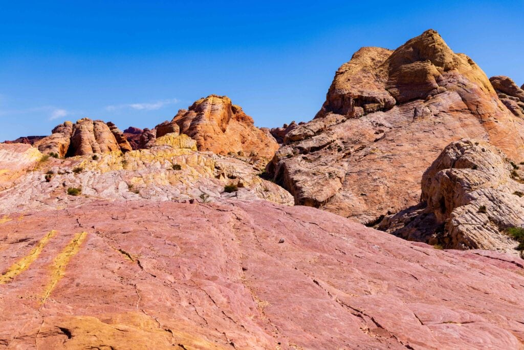 colorful rocks and white domed rocks near the trail at valley of fire