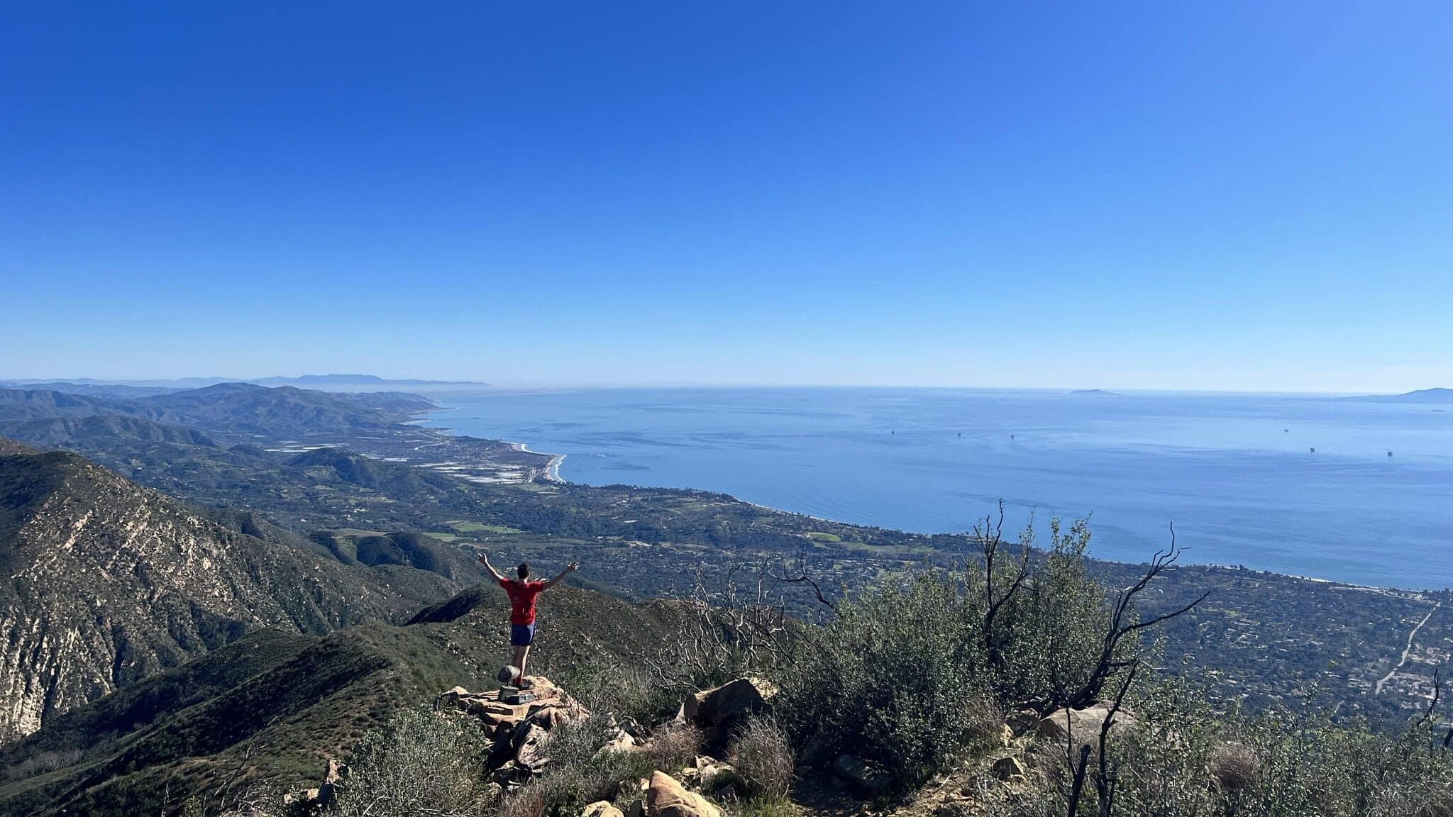 a man stands on a rock at Montecito peak one of the best hikes in santa barbara