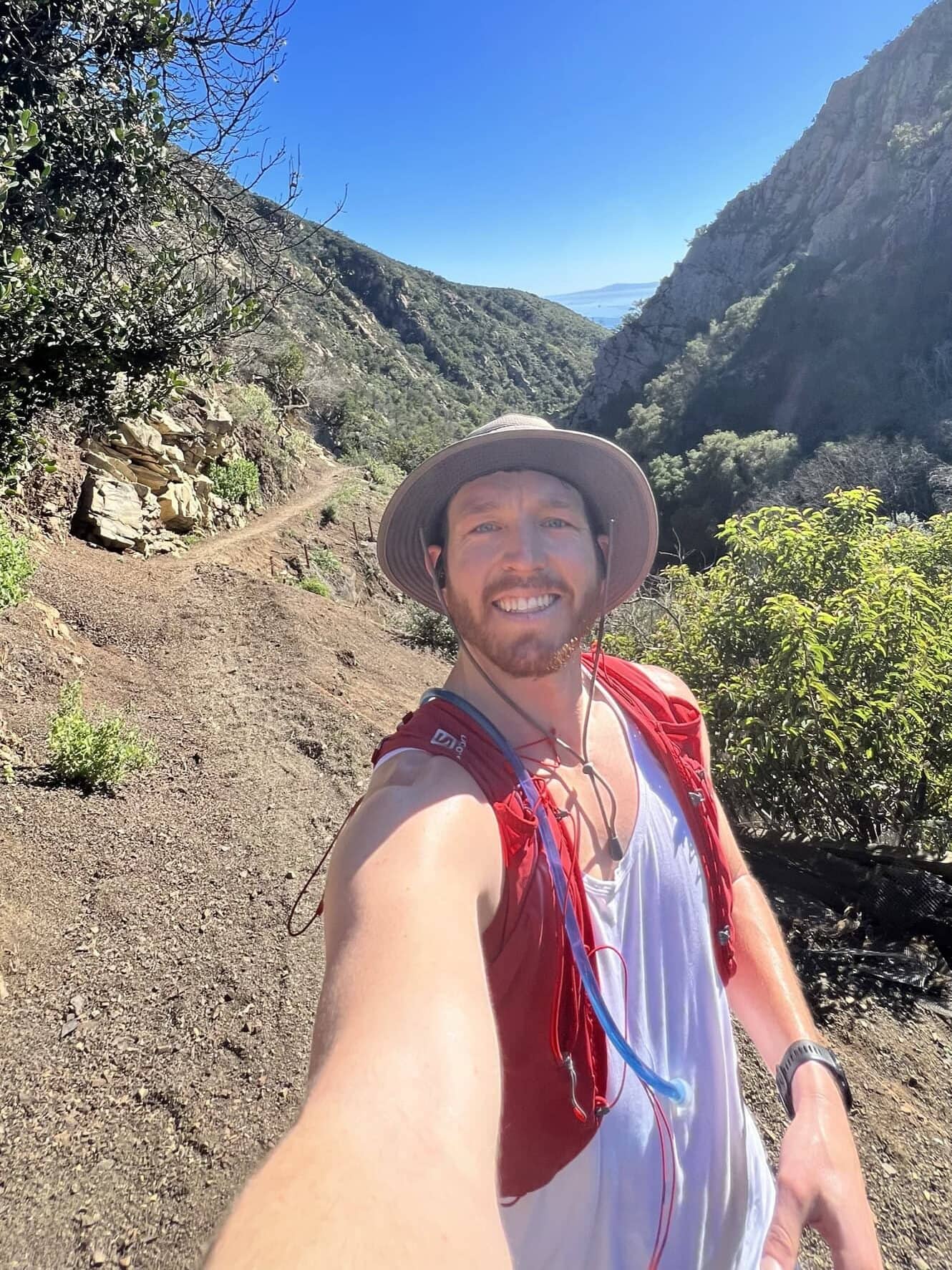 a hiker smiles at the camera while hiking in santa barbara