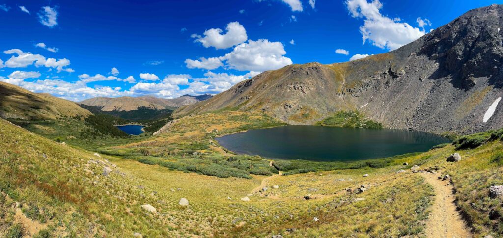 panorama photo of silver dollar lake and a lake below in colorado