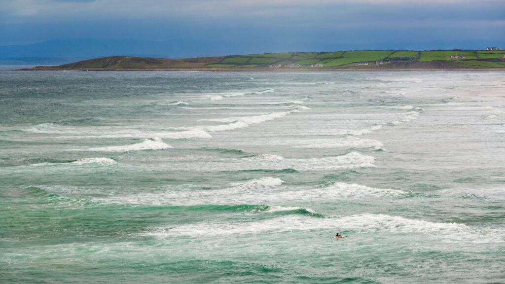 surfers in the water in ireland