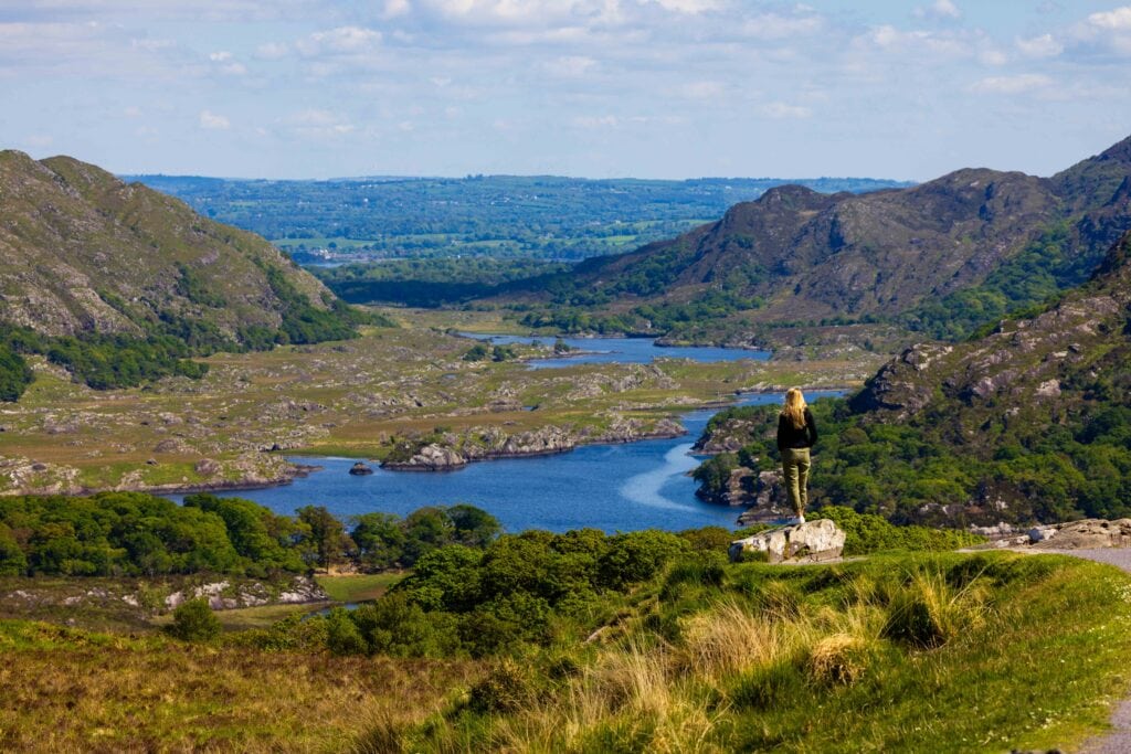 a female tourist stares out at the lakes in killarney national park