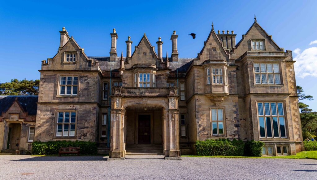 the massive muckross house with gorgeous architecture and windows