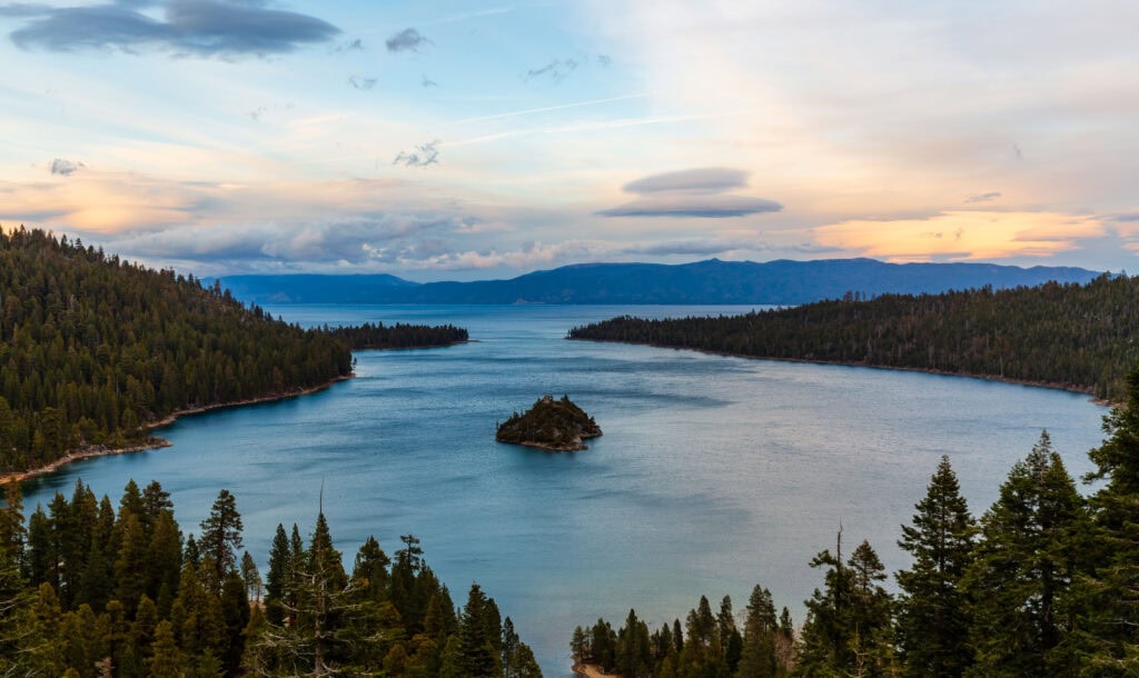 looking out at emerald bay at sunset. there's a small island in the middle of the bay