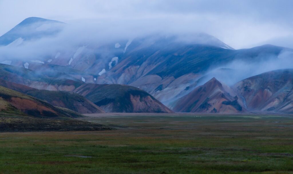 fog rolls over the hills of landmannalaugar in icland