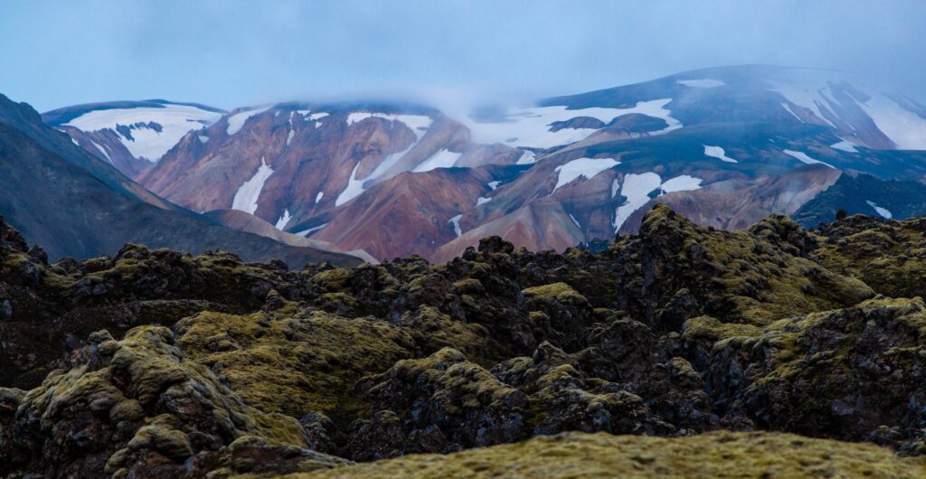 snowy mountains with the mossy lava rocks