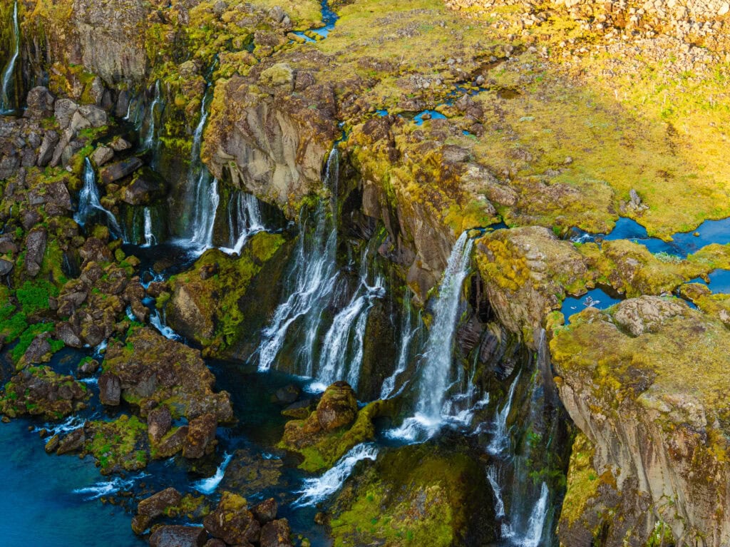 waterfalls flowing into a canyon in the valley of tears in iceland