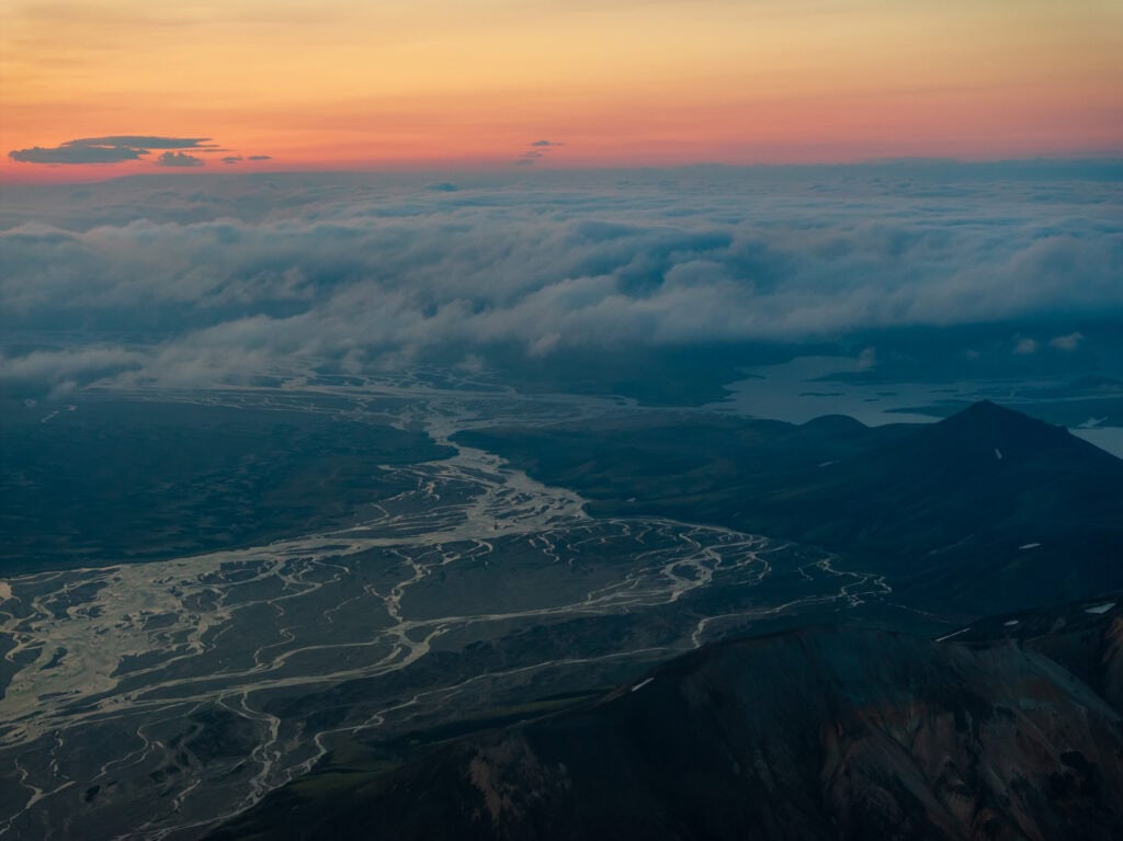 the midnight sun with fog rolling in towards landmannalaugar