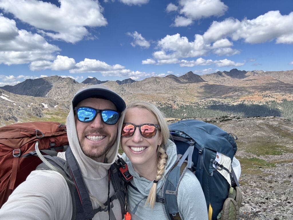 two backpackers smile at the camera the author is on the left
