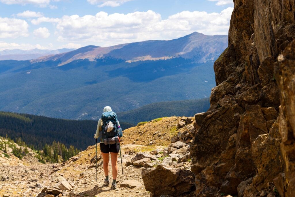a hiker on the trail between fancy lake and fancy pass
