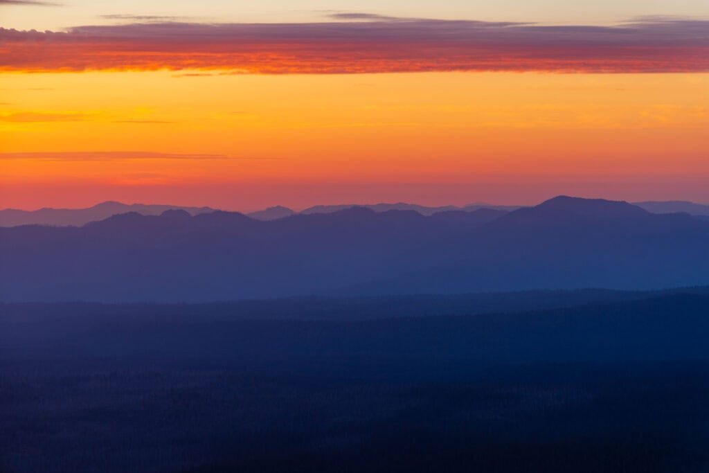 mountains and sunset colors looking west at crater lake national park