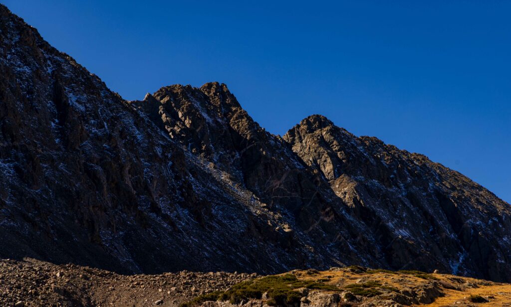 jagged peaks of the colorado rockies with a light dusting of snow