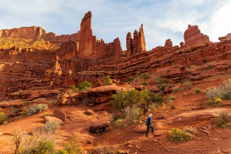 a hiker walks on the fisher towers trail near moab in utah
