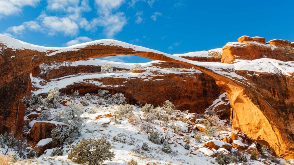 landscape arch covered ins now during a blue bird day in utah