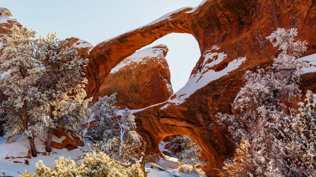 double o arch in arches national park with snow on it