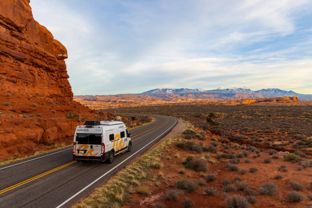 a camper van drives on the main road in arches national park