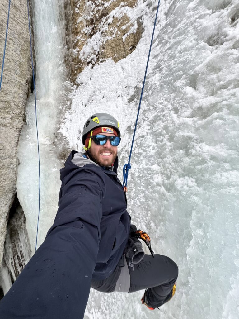 the author selfie-ing on while roped in on the wall