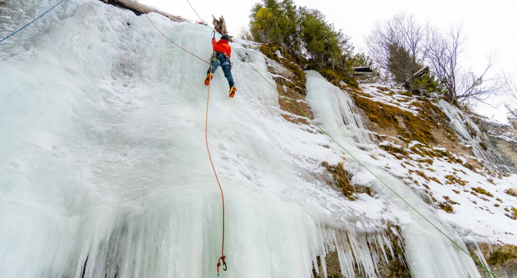 a climber on a wall of ice