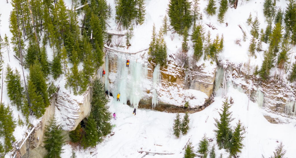 areial view of ice climbers on a frozen waterfall in wyoming