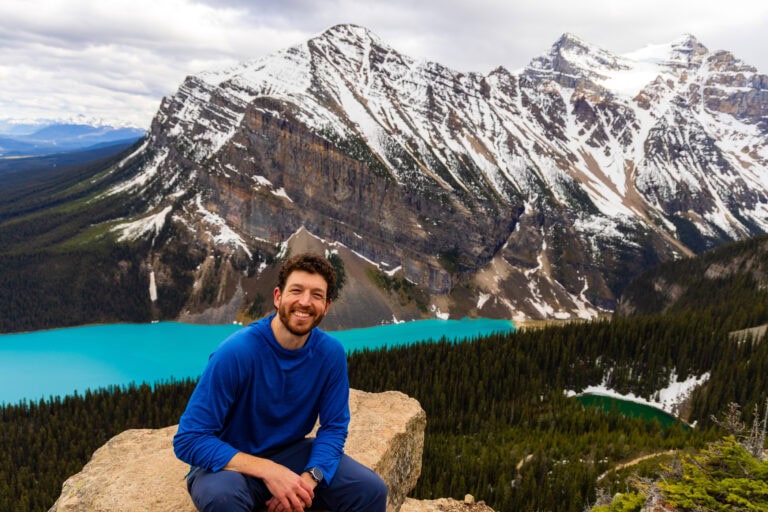 the author smiling at the camera on top of little beehive in canada