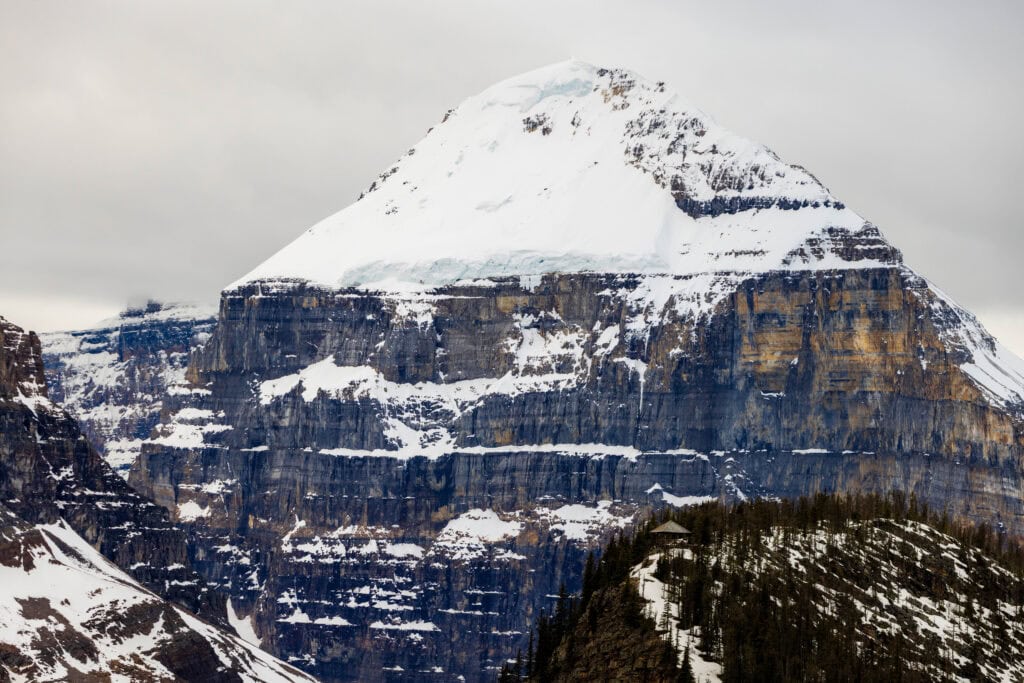 a snow covered peak with the shelter at big beehive in banff