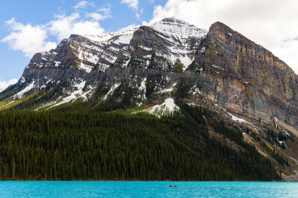 a canoe in the middle of lake louise in canada