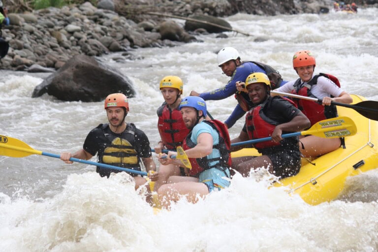 a group goes white water rafting in cost rica on a fast river