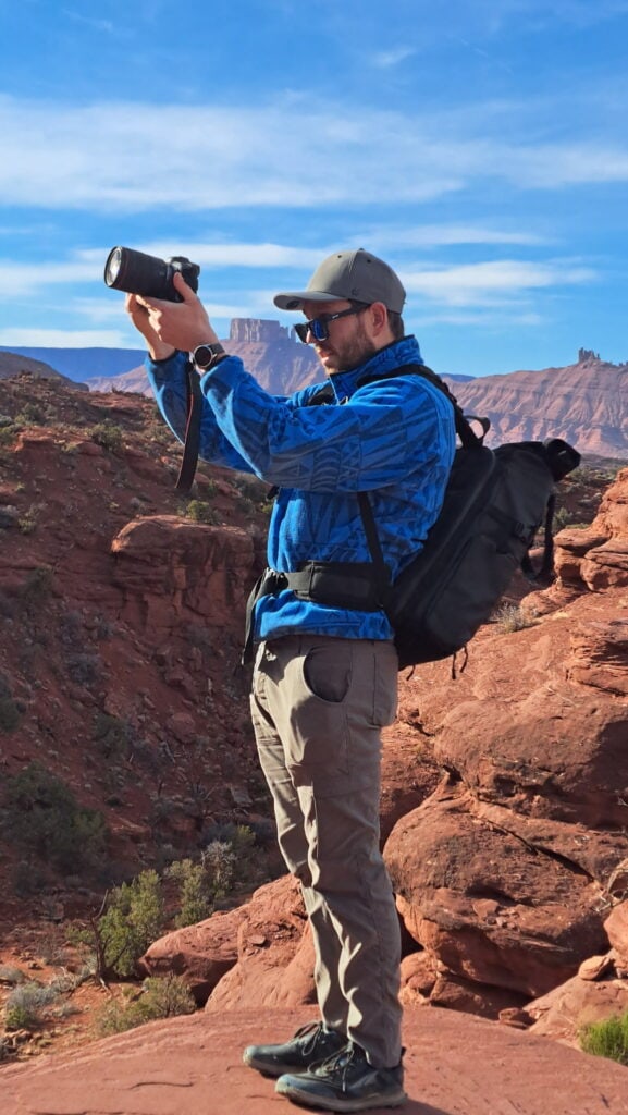 a photographer looks through the rear screen on his canon camera