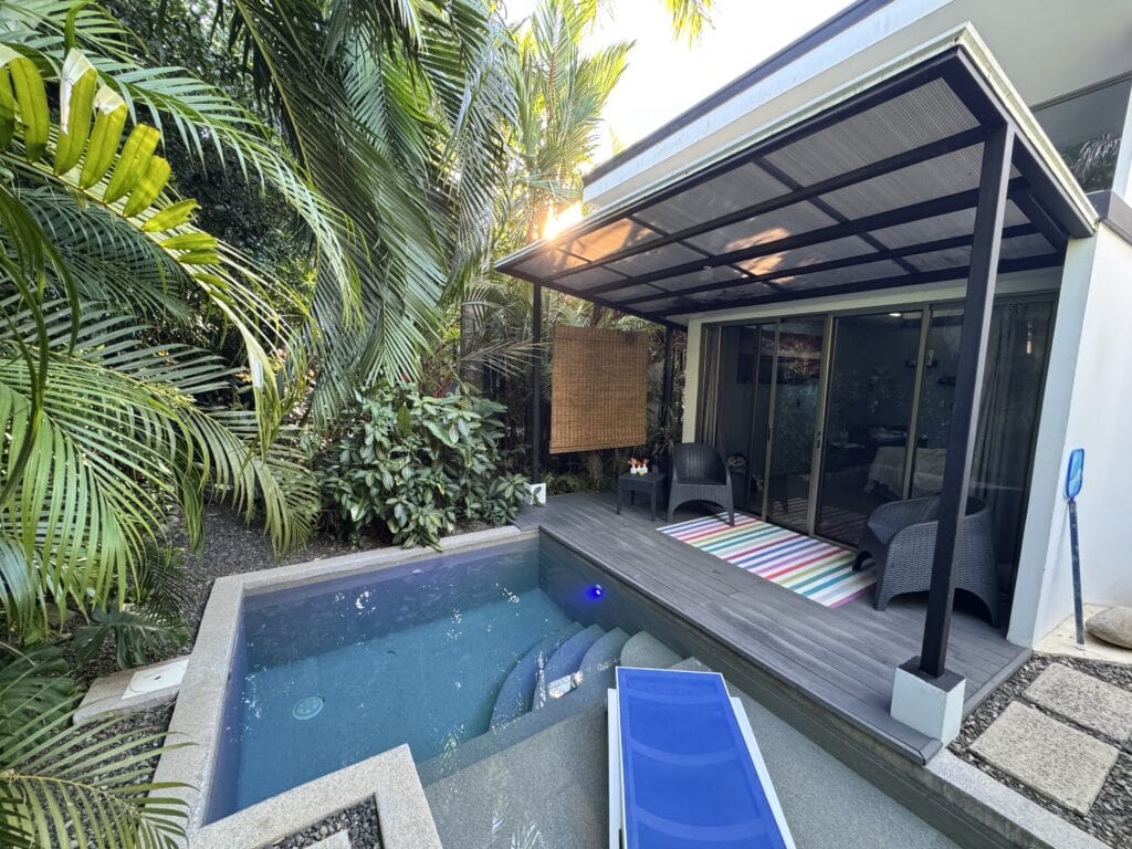airbnb in uvita with a pool surrounded by green trees