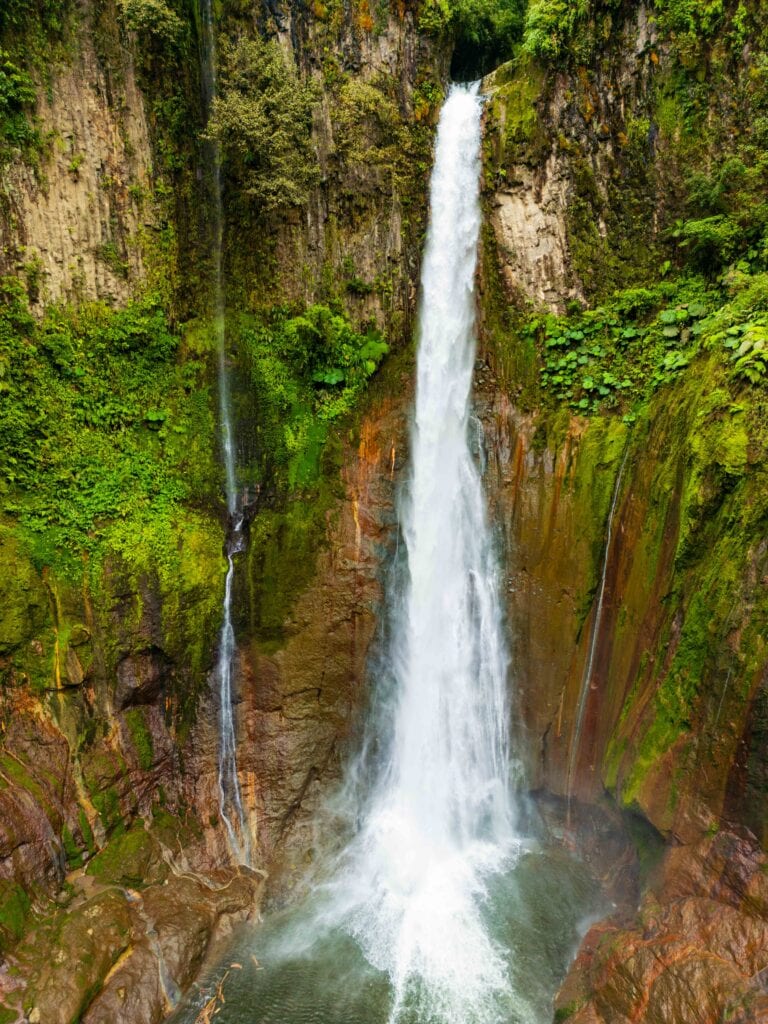 the catarata del toro waterfall falling into an extinct volcanic crater
