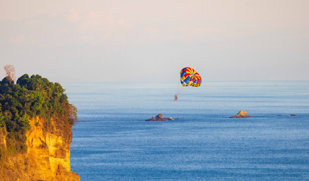 a parasailer flying before sunset
