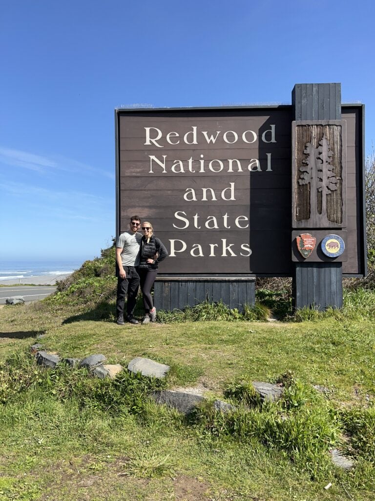The author and his now-wife at the sign for redwood national and state park